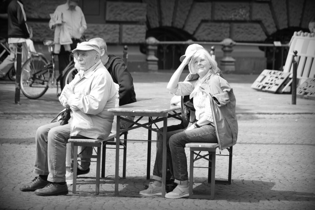 Elderly couple sitting at a portable table in the Domplatz, Bremen