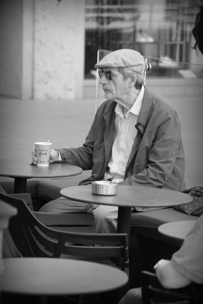 A man sitting alone drinking coffee in Hannover.