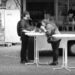 A couple eating at a standing table in front of a mobile canteen, Bremen.