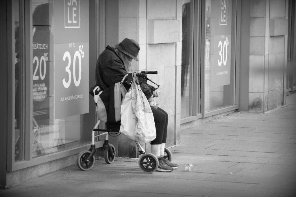 A woman sitting in Bremen, begging.