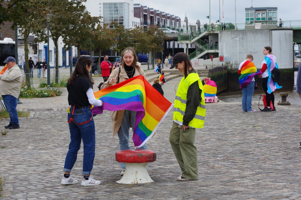 A colourful group of three, preparing for CSD Bremerhaven