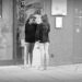 A young woman street singer taking a break to check herself in a mirror, in Osnabrück.