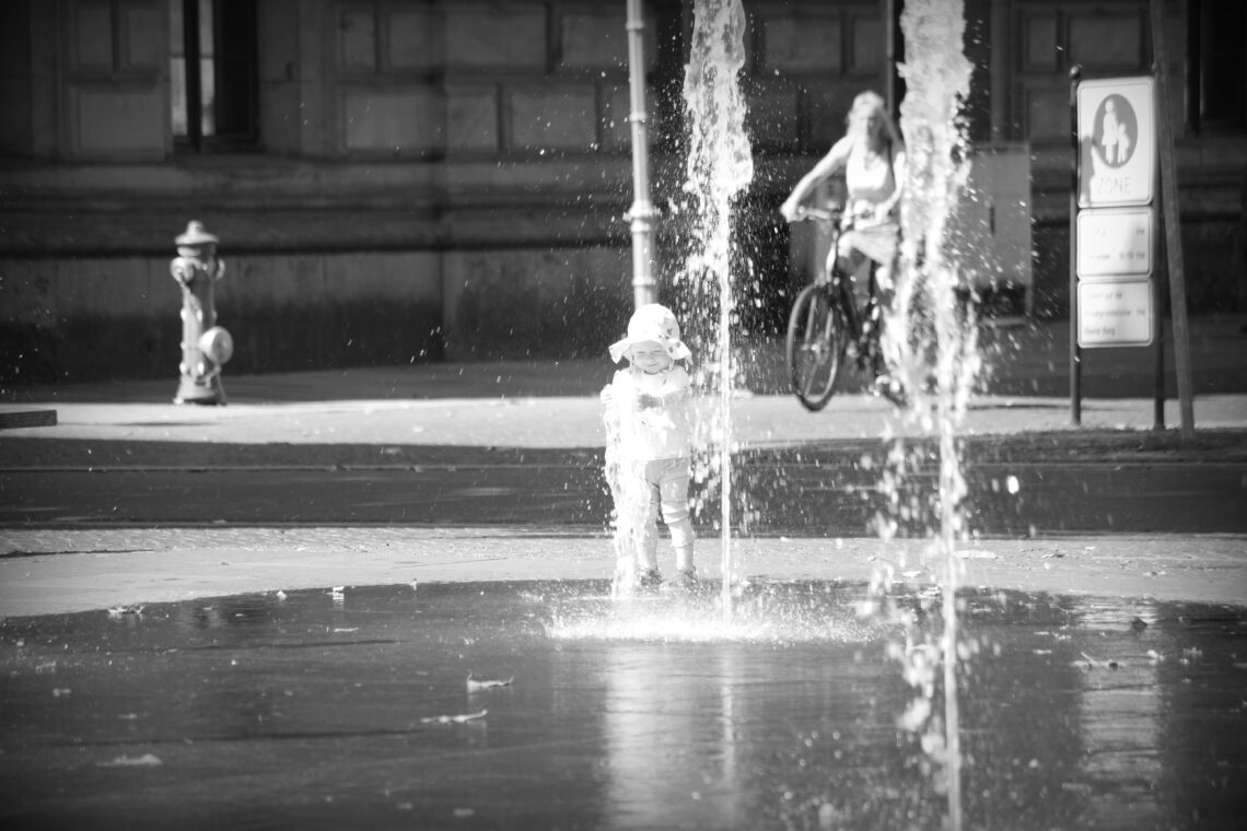 A small child fascinated by the water fountains in Braunschweig.