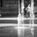 A small child fascinated by the water fountains in Braunschweig.