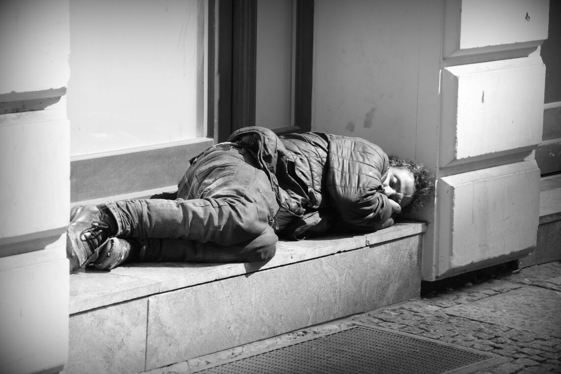 Homeless man sleeping in a closed doorway in Braunschweig.