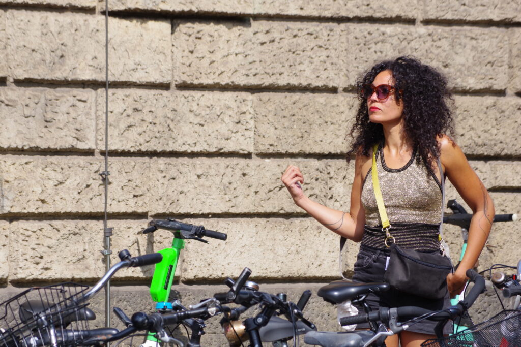 CSD Bremen: A young person parking their bicycle next to the Police station Am Wall prior to the parade.