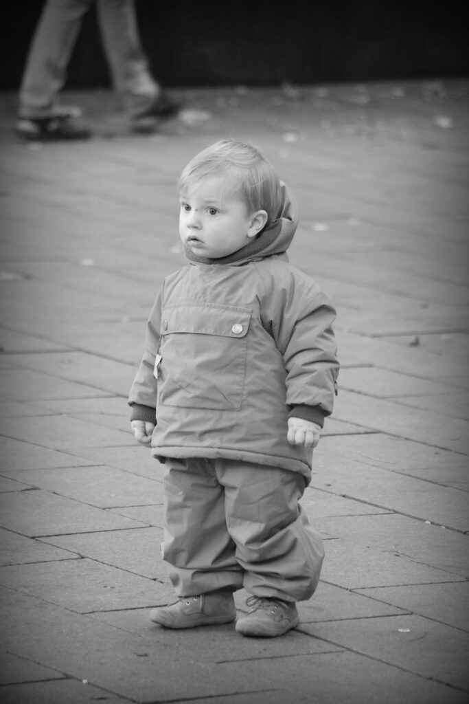 A young child standing in the street in Bremen, Germany. Copyright: Urban Camera, 2025.